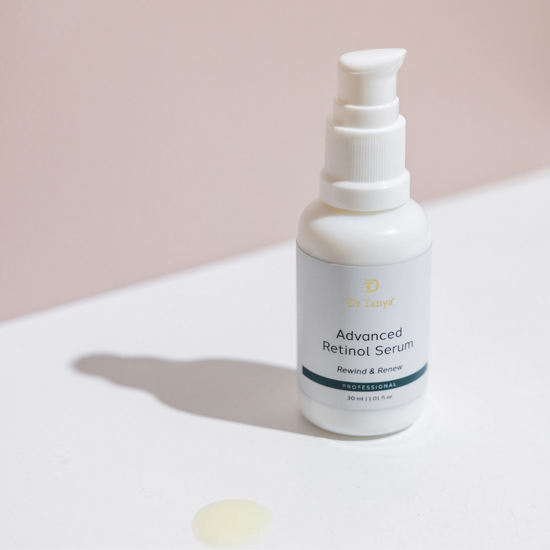 A white bottle of retinol serum with the cap off