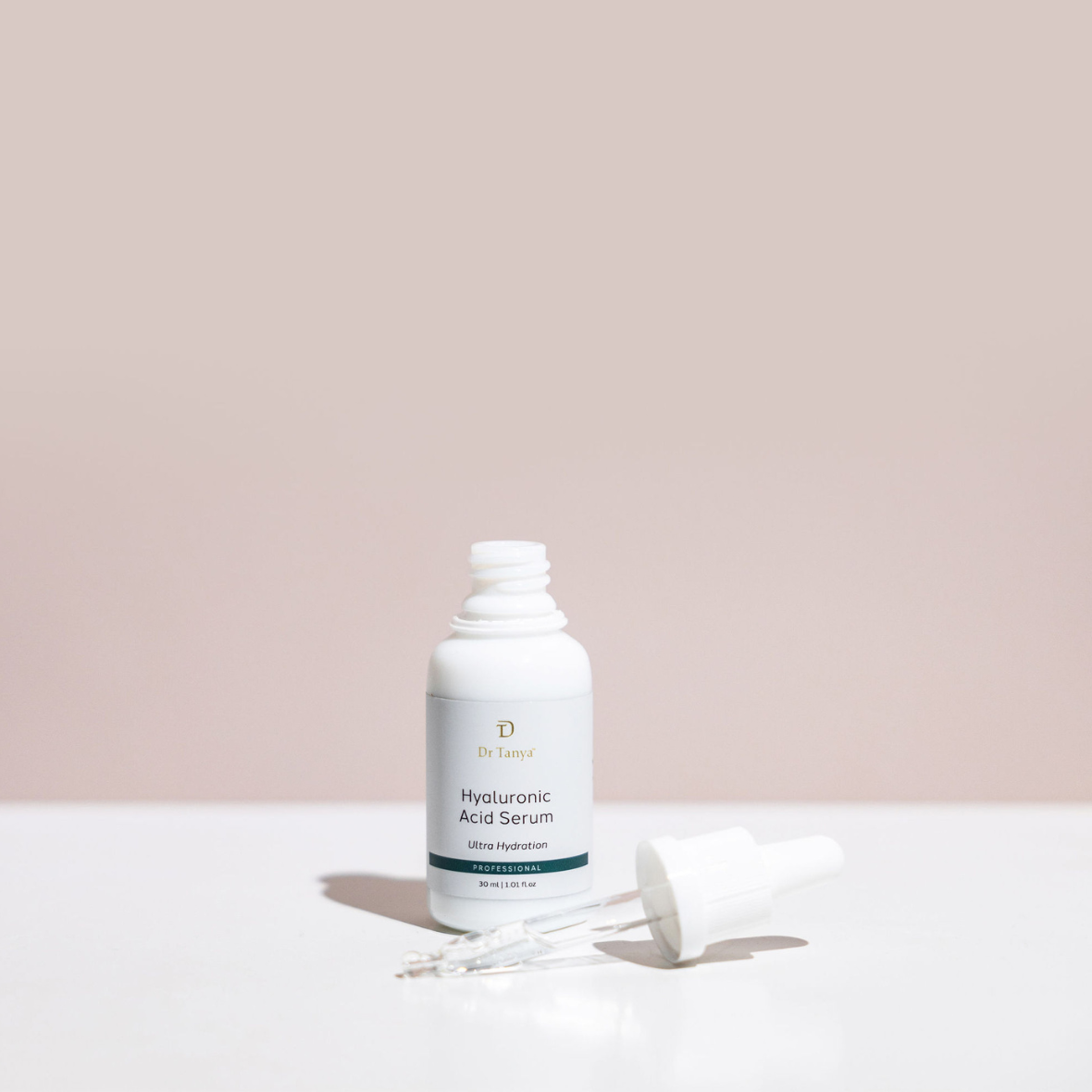 An open bottle of hyaluronic acid serum