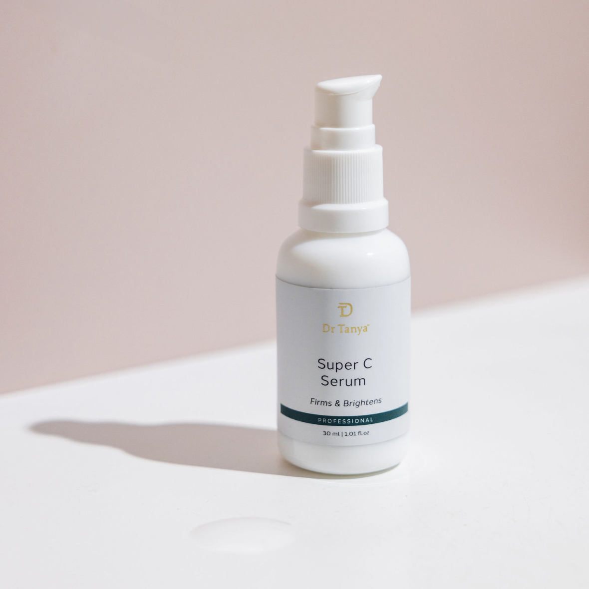 a white and green bottle of super c serum