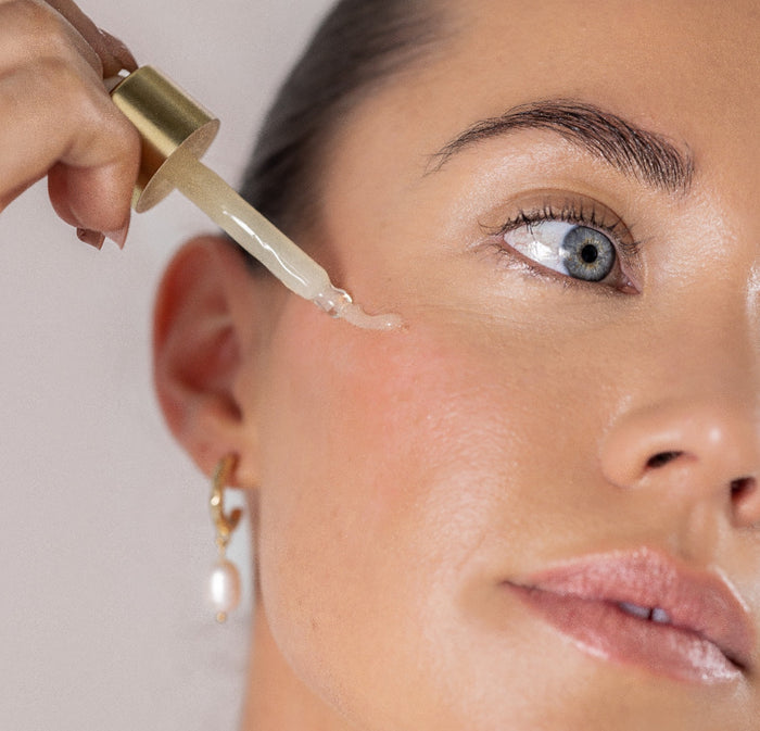 A lady applying eye serum
