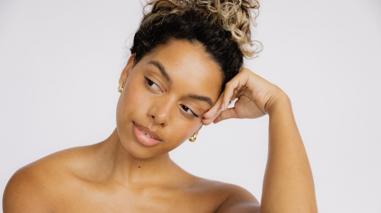 A woman looks to the side pensively