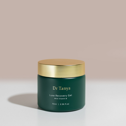 A green circular pot of luxe facial gel with a gold lid